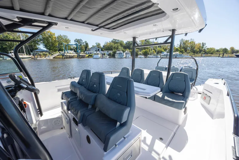  Yacht Photos Pics 2022 Axopar 37 Sun Top boat interior with seating and table on a sunny day.