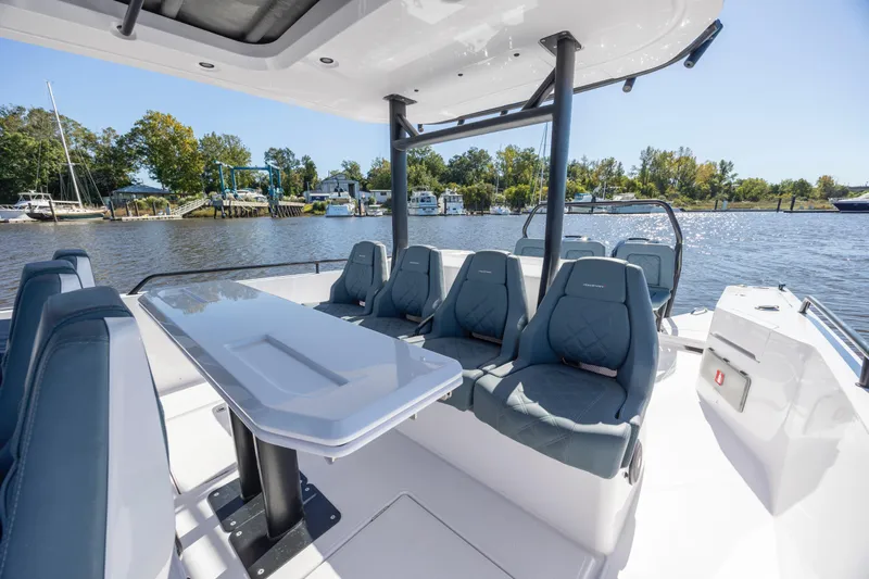  Yacht Photos Pics 2022 Axopar 37 Sun Top boat interior with seating and table on a sunny day.