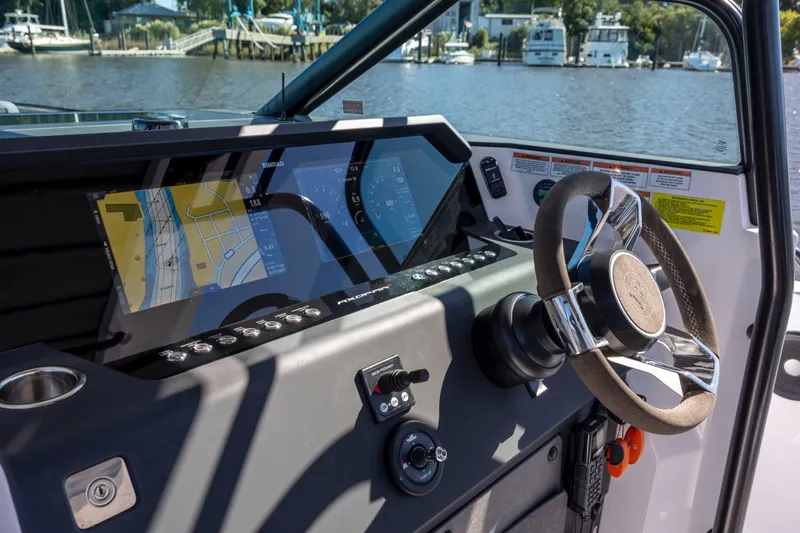  Yacht Photos Pics 2022 Axopar 37 Sun Top helm with advanced navigation displays and steering wheel.