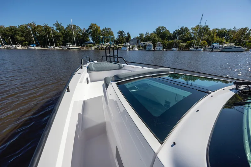  Yacht Photos Pics 2022 Axopar 37 Sun Top boat on calm water, featuring sleek design and spacious deck.