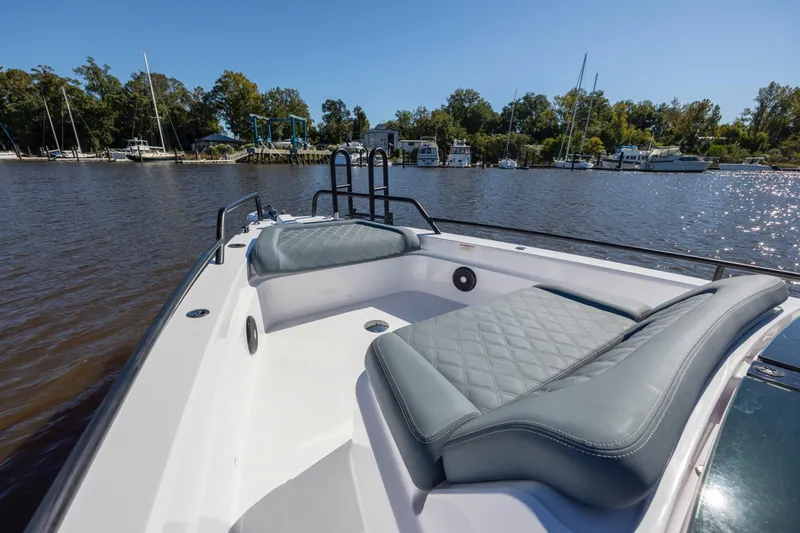  Yacht Photos Pics 2022 Axopar 37 Sun Top boat with cushioned seating, docked near a marina.