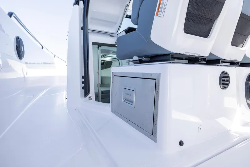  Yacht Photos Pics 2022 Axopar 37 Sun Top interior with seating and storage compartment.