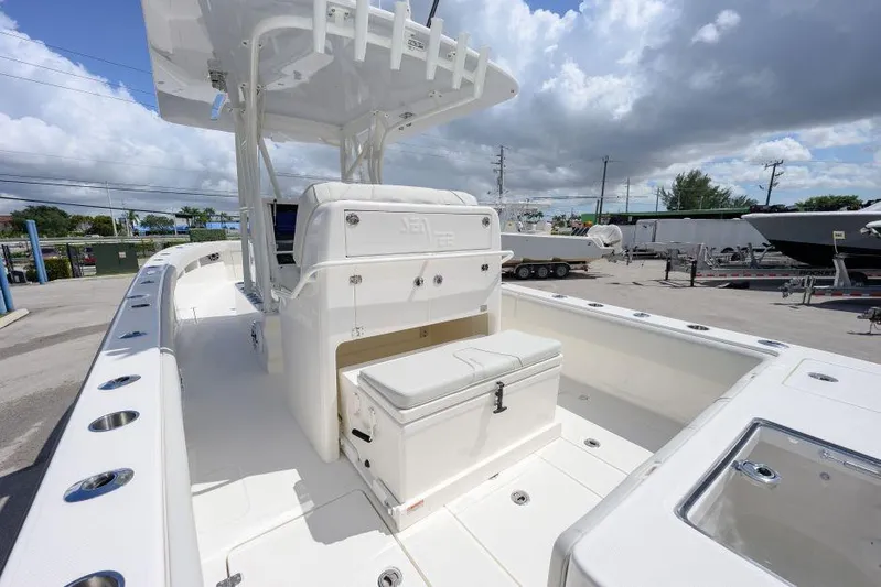  Yacht Photos Pics 2025 SeaVee 320B boat interior with seating and storage, under a cloudy sky.