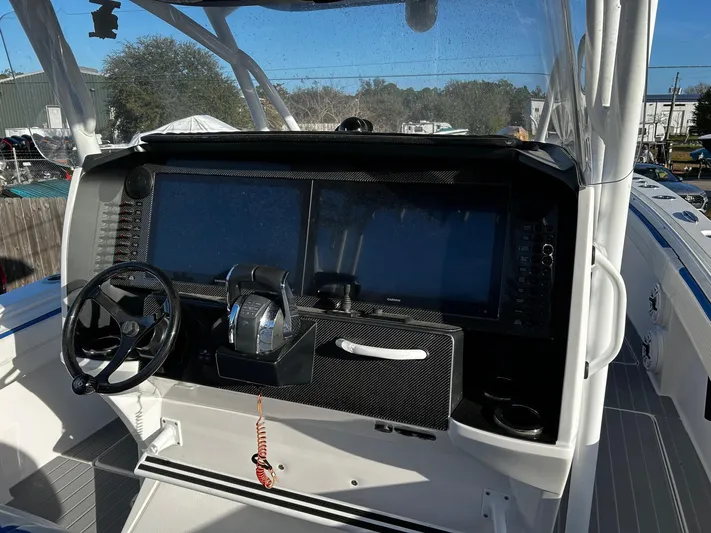  Yacht Photos Pics 2022 Nor-Tech 392 Superfish boat dashboard with steering wheel and control panel.