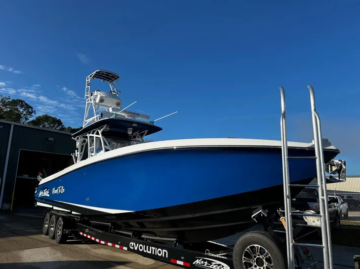  Yacht Photos Pics 2022 Nor-Tech 392 Superfish boat on trailer, blue hull, clear sky background.