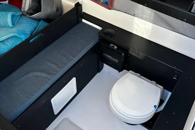  Yacht Photos Pics 2022 Nor-Tech 392 Superfish cabin interior with toilet and seating area.