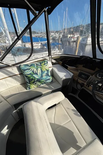 Busy Living Yacht Photos Pics Interior of 2001 Carver 396 Aft Cabin MY with plush seating and tropical pillow.