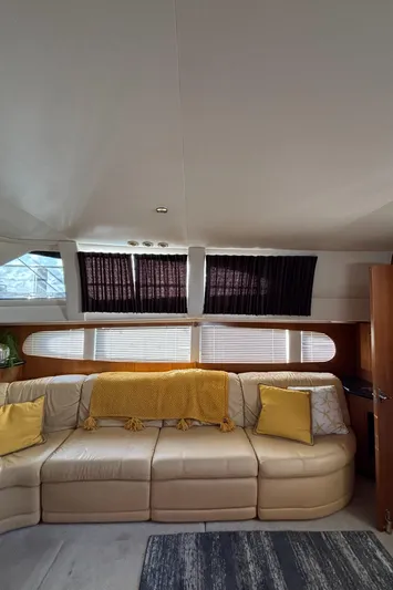 Busy Living Yacht Photos Pics Interior of 2001 Carver 396 Aft Cabin MY with beige sofa and yellow accents.