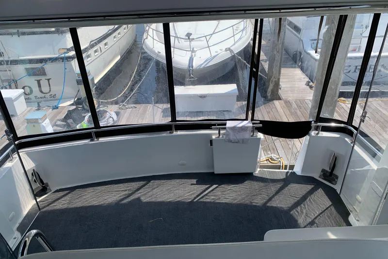 Busy Living Yacht Photos Pics 2001 Carver 396 Aft Cabin MY interior view, docked with surrounding boats.