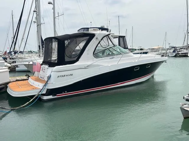  Yacht Photos Pics 2007 Four Winns 378 Vista yacht docked in marina, featuring sleek design and black canvas cover.