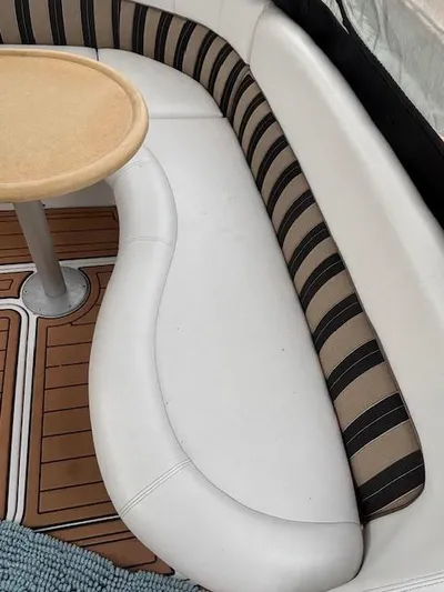  Yacht Photos Pics 2007 Four Winns 378 Vista boat interior with curved seating and wooden table.