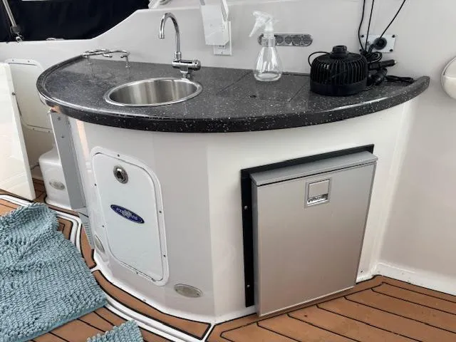  Yacht Photos Pics 2007 Four Winns 378 Vista yacht kitchenette with sink, mini fridge, and countertop.