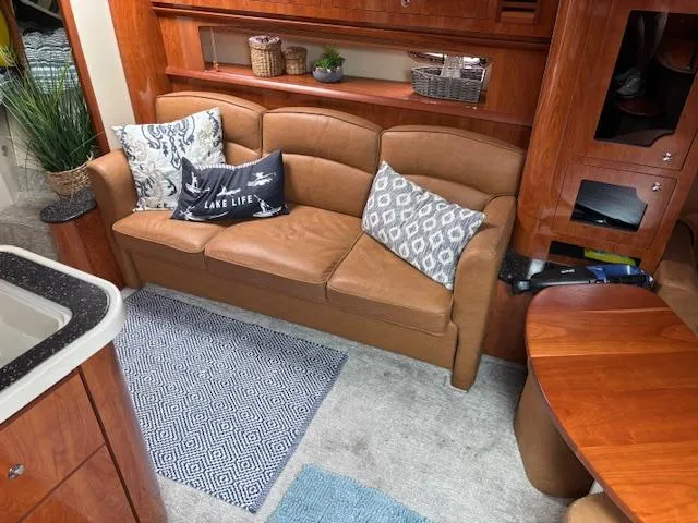  Yacht Photos Pics Luxurious interior of 2007 Four Winns 378 Vista with leather sofa and decorative pillows.