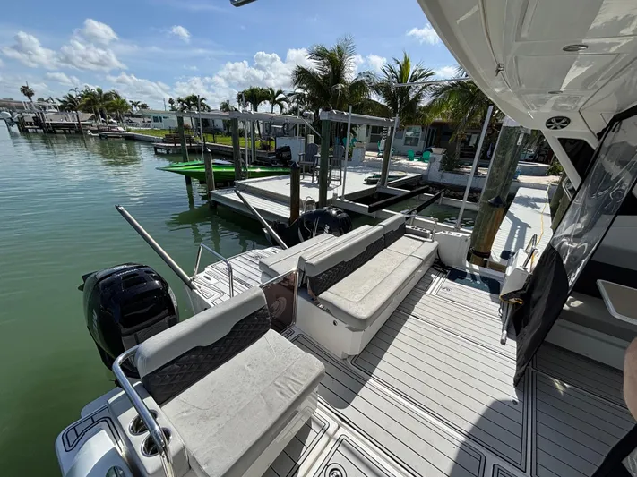 Namaste Yacht Photos Pics Aquila 36 Sport 2018 boat docked, featuring spacious seating and scenic waterfront view.