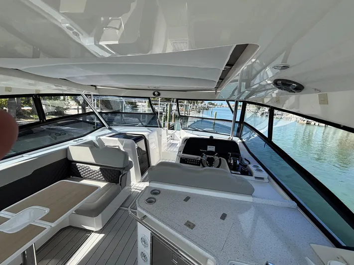 Namaste Yacht Photos Pics Interior view of 2018 Aquila 36 Sport yacht with modern seating and helm.