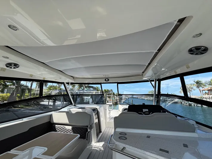 Namaste Yacht Photos Pics Interior view of 2018 Aquila 36 Sport yacht with modern seating and scenic waterway.