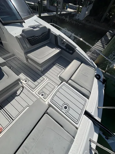 Namaste Yacht Photos Pics Aquila 36 Sport 2018 boat deck with cushioned seating and sleek design.