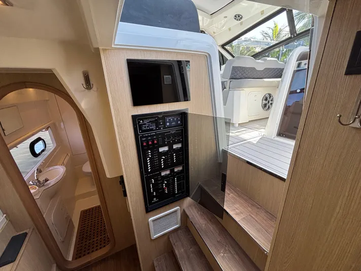 Namaste Yacht Photos Pics Interior of 2018 Aquila 36 Sport yacht, featuring control panel and cabin access.