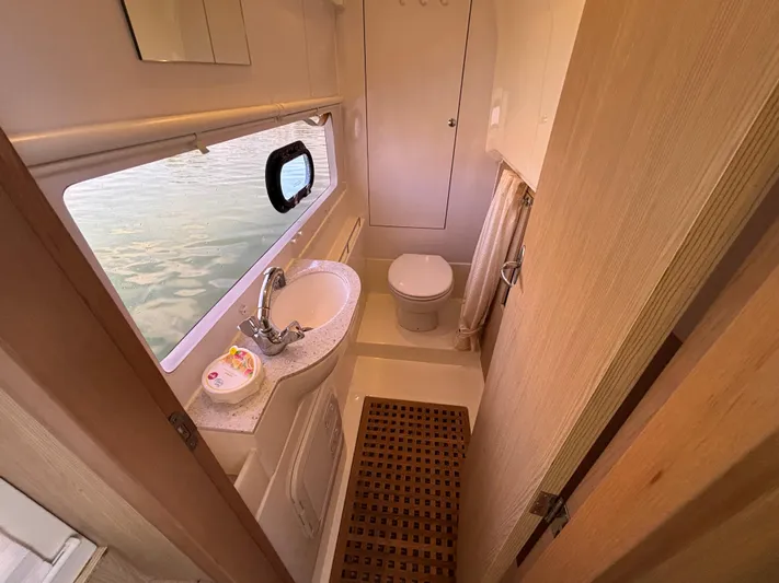 Namaste Yacht Photos Pics Bathroom interior of 2018 Aquila 36 Sport yacht with sink, toilet, and window view.