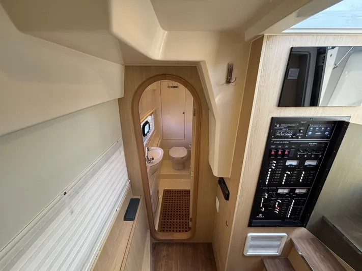 Namaste Yacht Photos Pics Interior of 2018 Aquila 36 Sport yacht, featuring a compact bathroom and control panel.