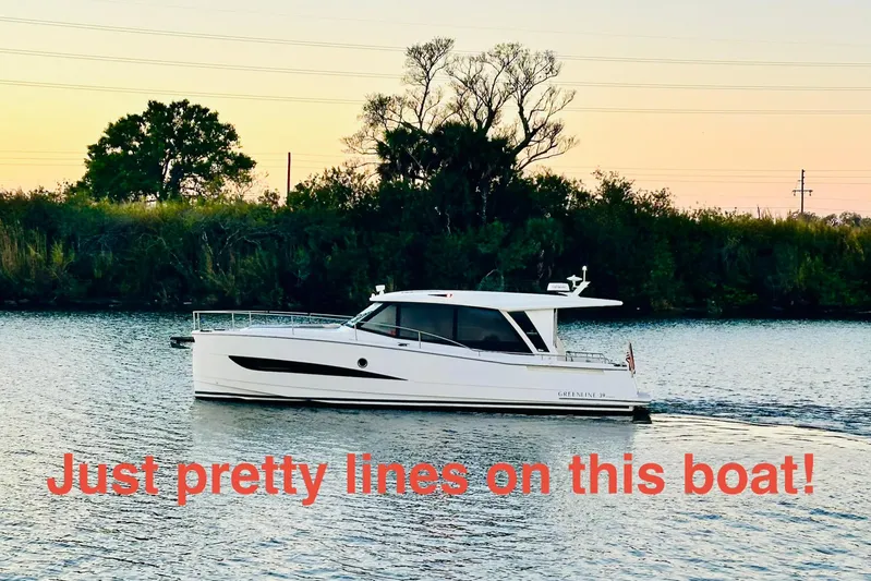 Least Expensive 39 Hybrid In The Country Yacht Photos Pics 2021 Greenline 39 Hybrid boat cruising on a serene river at sunset.