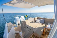 Luxurious Nimbus W11 2023 boat with spacious deck, comfortable seating, and scenic ocean view.