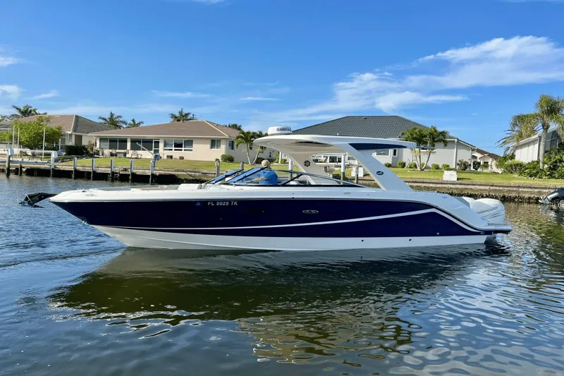  Yacht Photos Pics 2023 Sea Ray 310 SLX-OB boat on a sunny waterfront, featuring sleek design and modern architecture.