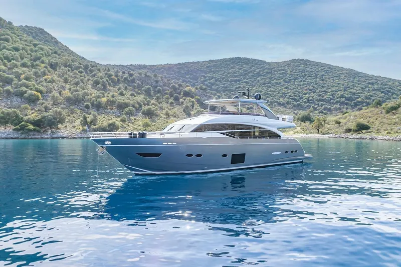 Lady Parisa Yacht Photos Pics Luxurious 2014 Princess 88 Motor Yacht cruising in serene, clear blue waters.