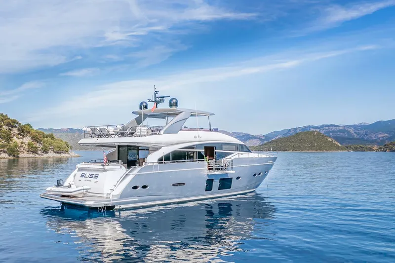 Lady Parisa Yacht Photos Pics Luxurious 2014 Princess 88 Motor Yacht on serene blue waters, surrounded by scenic hills.