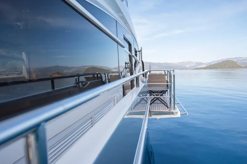 Lady Parisa Yacht Photos Pics Side view of a 2014 Princess 88 Motor Yacht on calm blue waters.