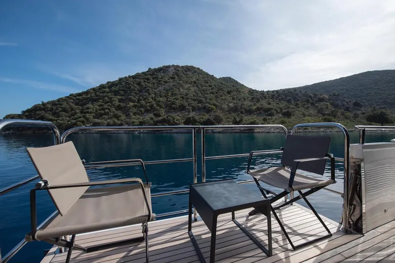 Lady Parisa Yacht Photos Pics Deck view from 2014 Princess 88 Motor Yacht, overlooking serene waters and lush hills.