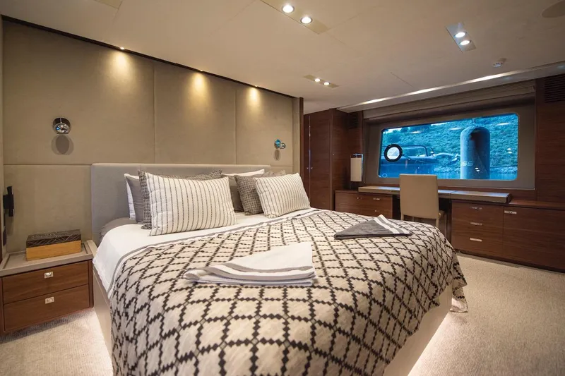 Lady Parisa Yacht Photos Pics Luxurious bedroom interior of 2014 Princess 88 Motor Yacht with elegant decor and large window view.