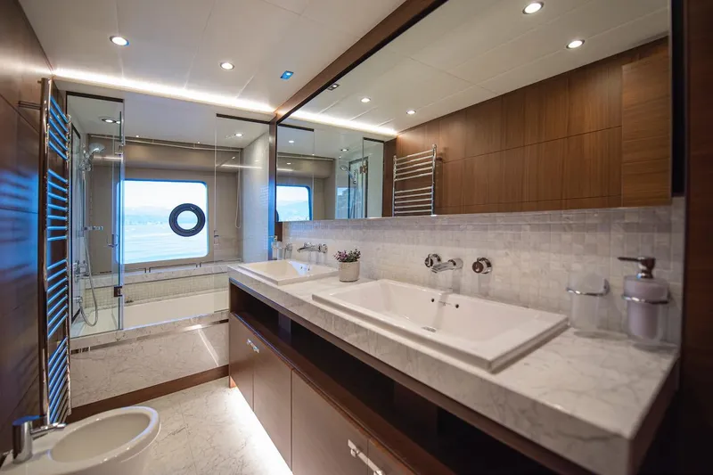 Lady Parisa Yacht Photos Pics Luxurious bathroom on 2014 Princess 88 Motor Yacht with marble sink and ocean view.