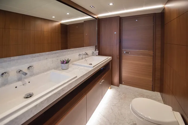 Lady Parisa Yacht Photos Pics Luxurious bathroom on 2014 Princess 88 Motor Yacht with marble countertops and wooden accents.