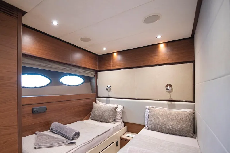 Lady Parisa Yacht Photos Pics Luxurious twin cabin interior on 2014 Princess 88 Motor Yacht, featuring elegant wood finishes.