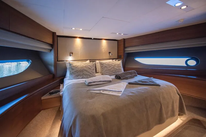 Lady Parisa Yacht Photos Pics Luxurious bedroom interior of 2014 Princess 88 Motor Yacht with elegant bedding and ambient lighting.