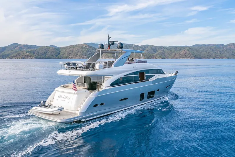 Lady Parisa Yacht Photos Pics 2014 Princess 88 Motor Yacht cruising on blue waters with scenic mountain backdrop.