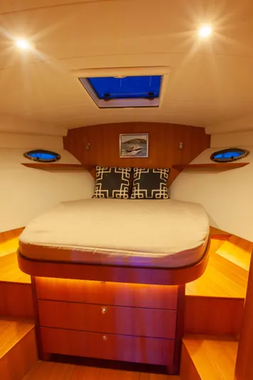  Yacht Photos Pics Luxurious cabin interior of 2018 Hylas M44 yacht with cozy bed and warm lighting.
