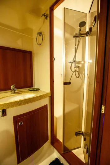  Yacht Photos Pics 2018 Hylas M44 yacht bathroom with modern shower and wooden cabinetry.