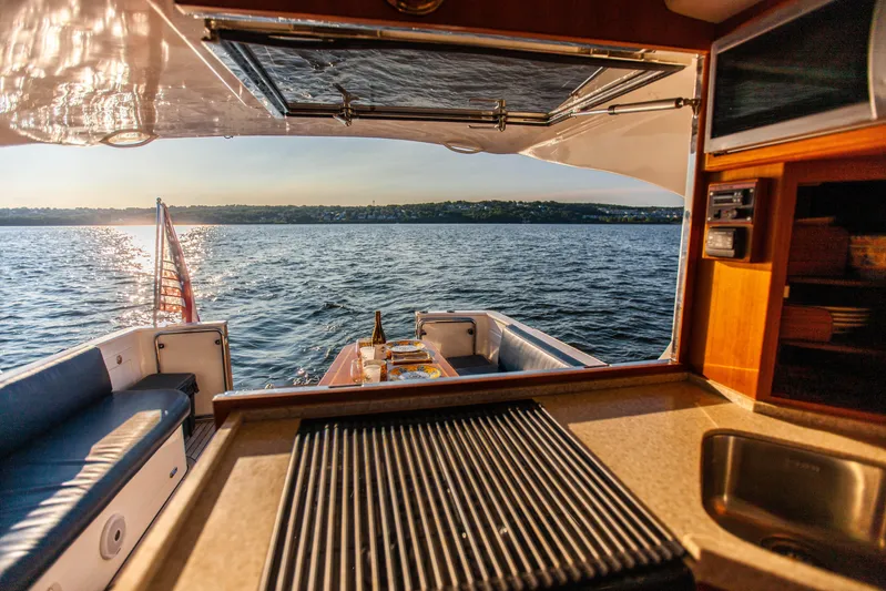  Yacht Photos Pics Interior view of 2018 Hylas M44 yacht overlooking serene ocean at sunset.