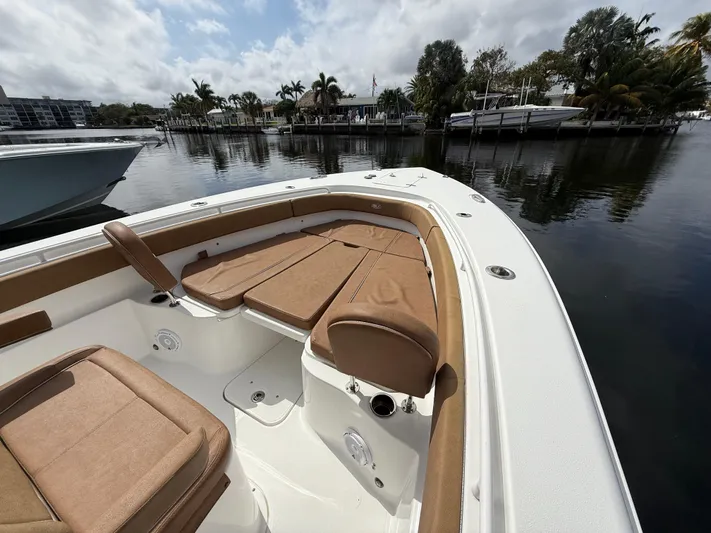  Yacht Photos Pics 2023 Sea Hunt Gamefish 30 Forward Seating boat docked by a calm waterfront.