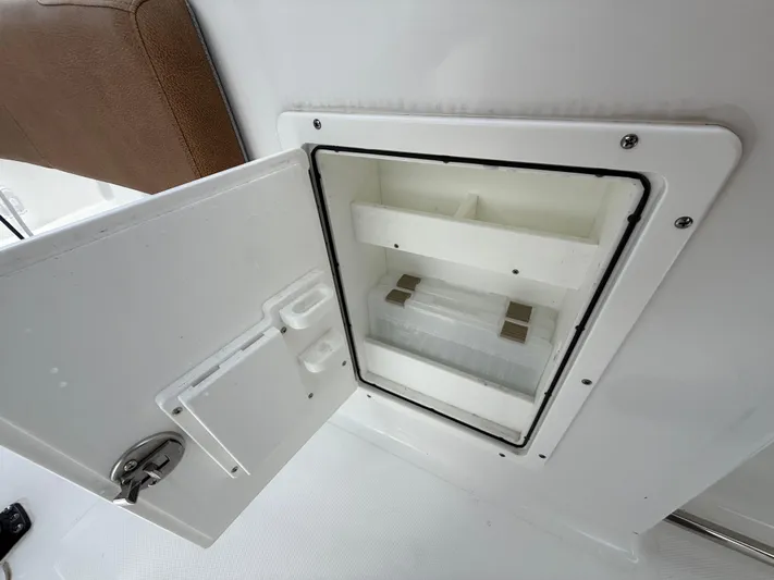  Yacht Photos Pics 2023 Sea Hunt Gamefish 30 storage compartment with open door, showcasing interior shelves.