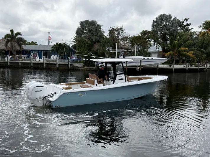  Yacht Photos Pics 2023 Sea Hunt Gamefish 30 boat with forward seating on a calm waterway.
