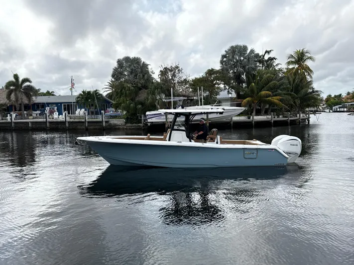  Yacht Photos Pics 2023 Sea Hunt Gamefish 30 boat on calm water near a tropical shoreline.