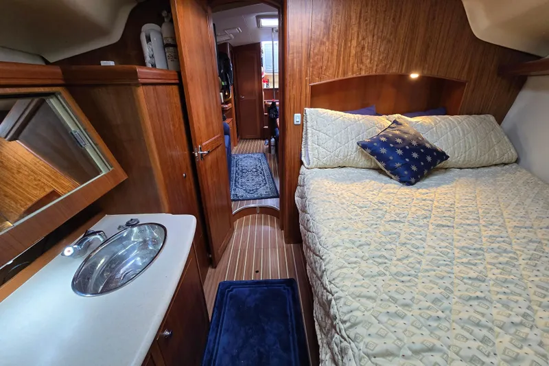 Scuba Duo Yacht Photos Pics Luxurious 2004 Hunter 41 AC yacht interior with cozy bedroom and elegant wood finish.