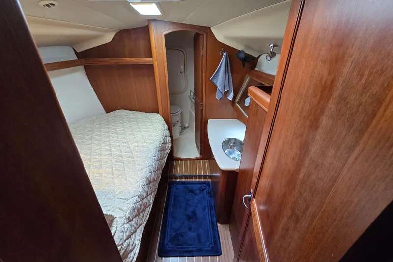 Scuba Duo Yacht Photos Pics Cozy cabin interior of 2004 Hunter 41 AC sailboat with bed and bathroom.