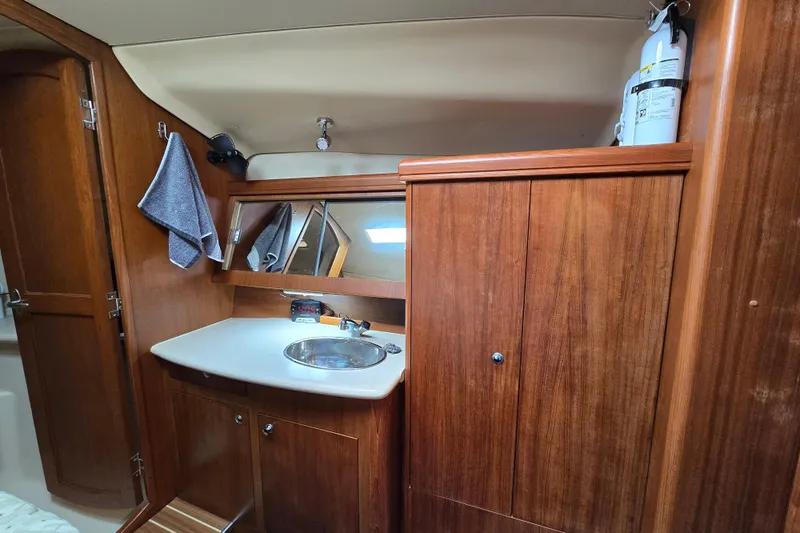 Scuba Duo Yacht Photos Pics Interior of 2004 Hunter 41 AC yacht bathroom with wooden cabinetry and sink.