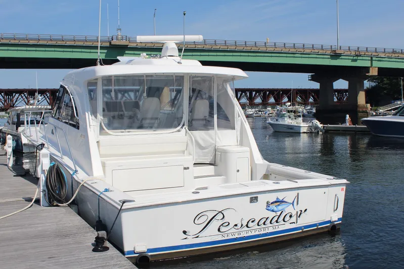 Pescador Yacht Photos Pics 2013 Cabo 40 Hardtop Express yacht docked near a bridge.