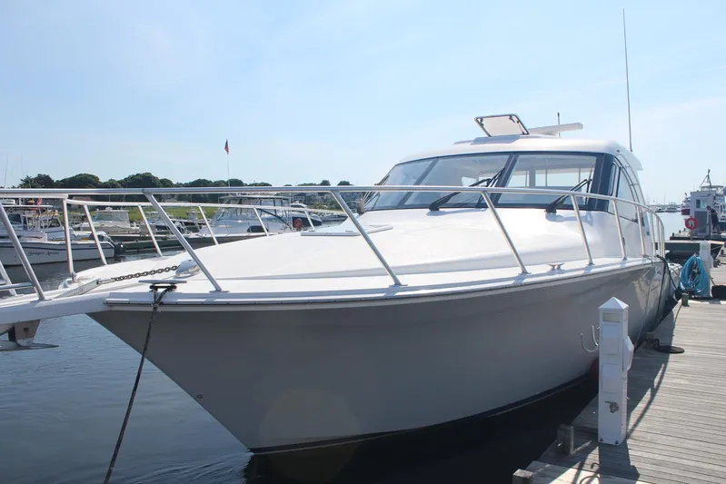 Pescador Yacht Photos Pics 2013 Cabo 40 Hardtop Express yacht docked at marina under clear sky.