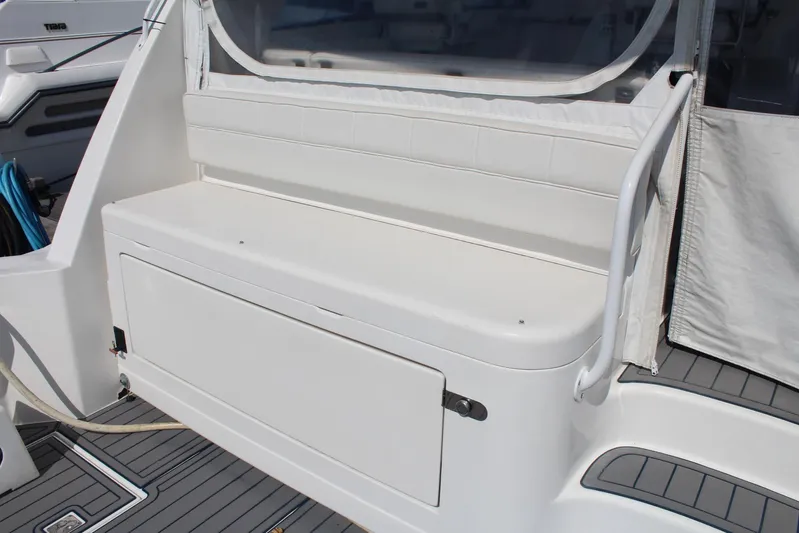 Pescador Yacht Photos Pics 2013 Cabo 40 Hardtop Express boat seating area with storage compartment.